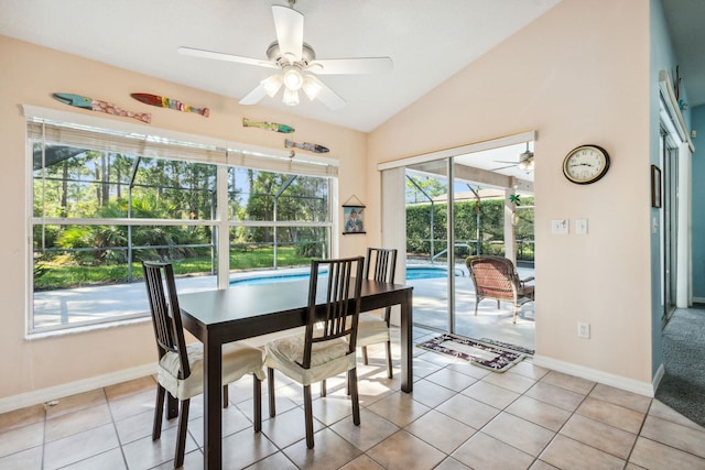 tiled dining space featuring ceiling fan and lofted ceiling