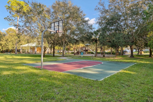 view of basketball court with a yard and a playground