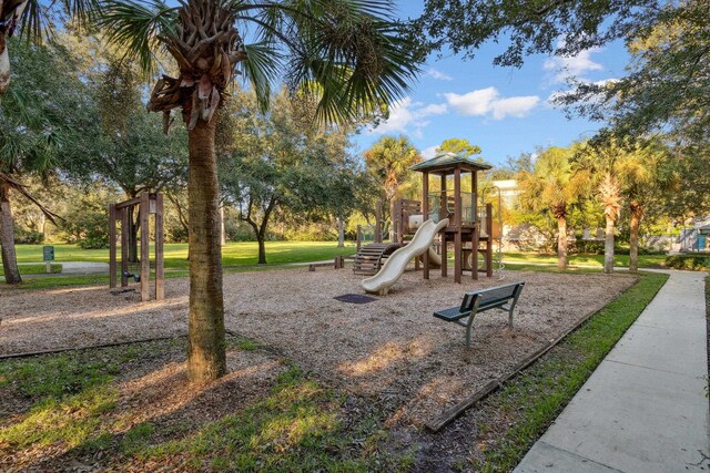 view of playground with a lawn