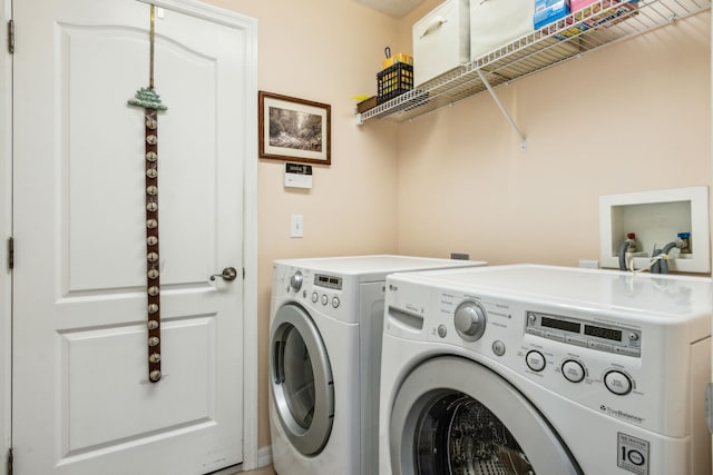 clothes washing area with washing machine and clothes dryer