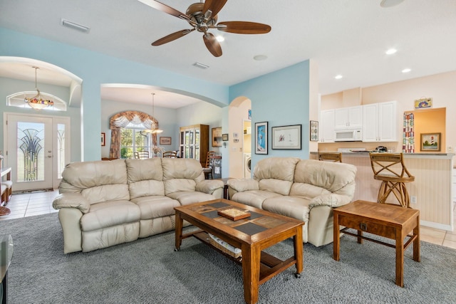 tiled living room featuring ceiling fan