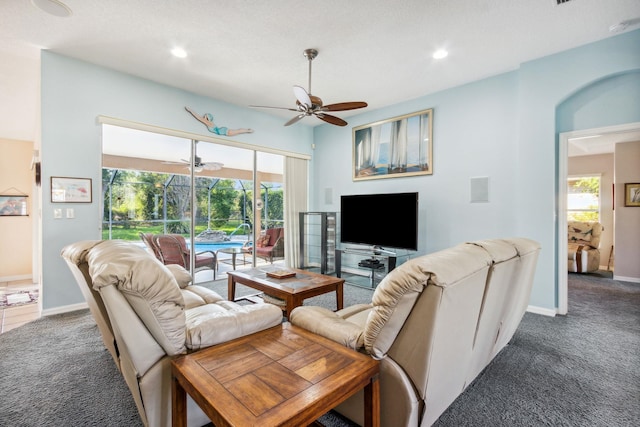 carpeted living room with ceiling fan