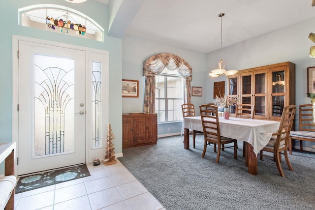 dining space featuring an inviting chandelier and light tile patterned flooring