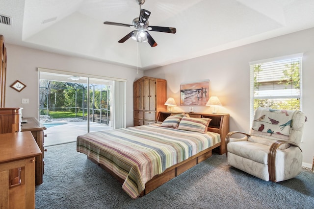 carpeted bedroom featuring access to outside, multiple windows, and ceiling fan