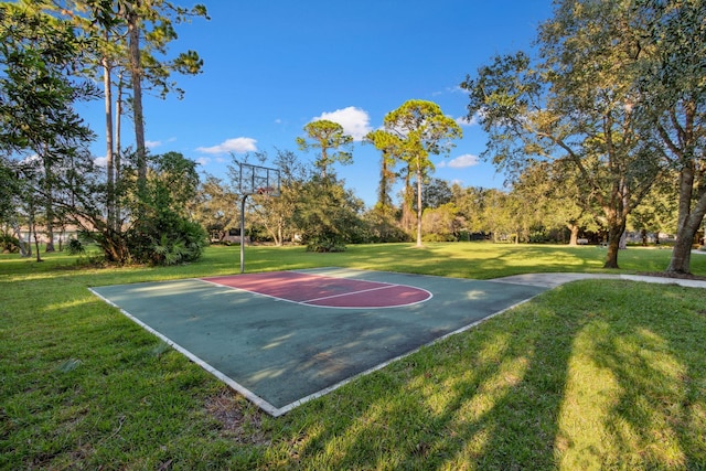 view of basketball court with a lawn