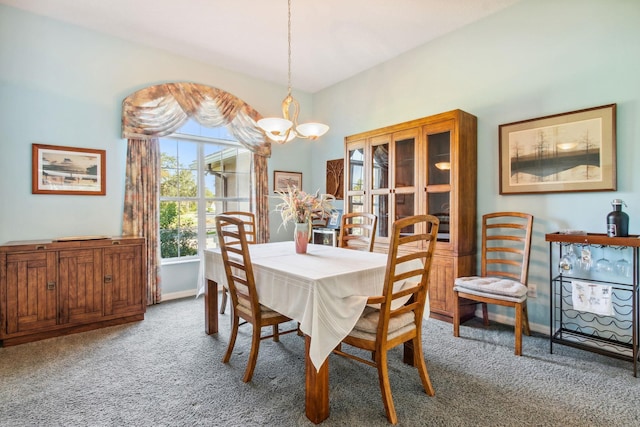 carpeted dining area featuring a notable chandelier