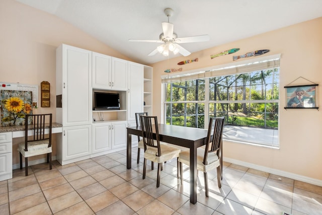 dining room with ceiling fan, light tile patterned flooring, and lofted ceiling