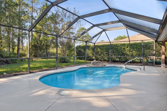 view of pool with glass enclosure and a patio