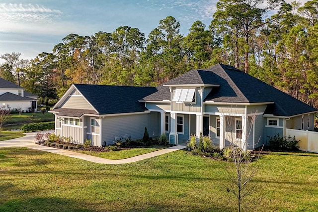 1351 Weaver Glen Rd, Jacksonville, FL 32223 - view of front of property featuring board and batten siding, a shingled roof, and view of wooded area