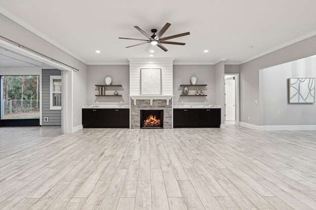 1351 Weaver Glen Rd, Jacksonville, FL 32223 - living area with light wood finished floors, a ceiling fan, recessed lighting, crown molding, and a warm lit fireplace