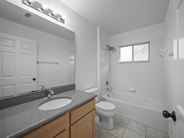 200 Springwood Ln, Saint Johns, FL 32259 - full bathroom with tile patterned flooring, a textured ceiling, toilet, vanity, and tiled shower / bath