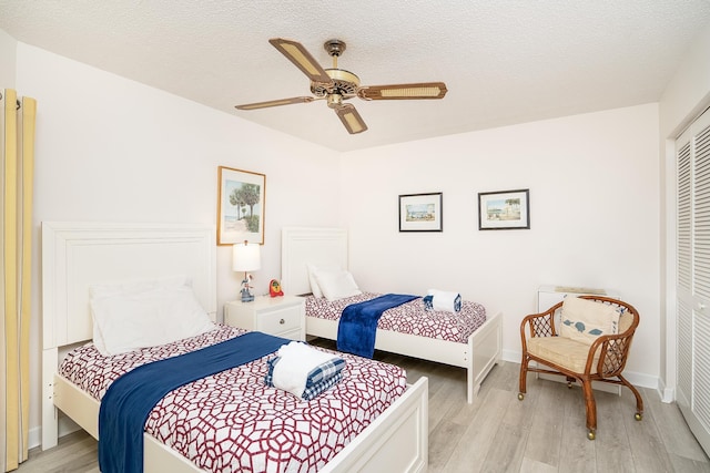 4250 A1A Unit E31, Saint Augustine Beach, FL 32080 - bedroom featuring light wood-style flooring, a closet, ceiling fan, a textured ceiling, and baseboards