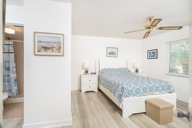 4250 A1A Unit E31, Saint Augustine Beach, FL 32080 - bedroom with light wood-type flooring, water heater, a textured ceiling, baseboards, and a ceiling fan