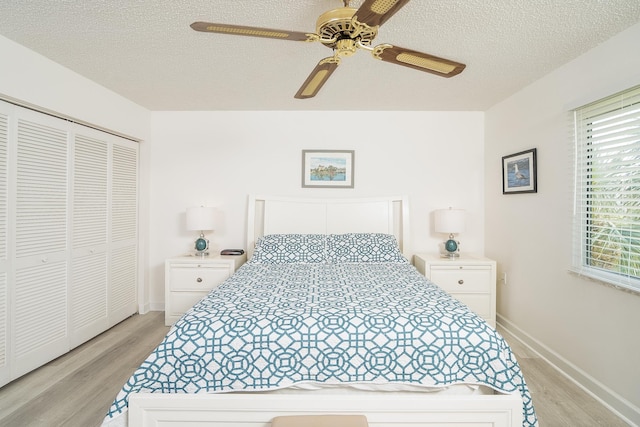4250 A1A Unit E31, Saint Augustine Beach, FL 32080 - bedroom featuring light wood finished floors, a textured ceiling, baseboards, a closet, and ceiling fan