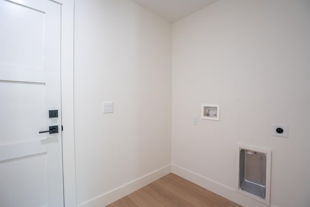 laundry area featuring light wood-style flooring, hookup for an electric dryer, baseboards, hookup for a washing machine, and laundry area