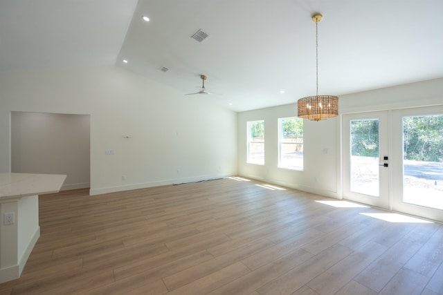 unfurnished living room with french doors, light wood-style flooring, visible vents, and baseboards