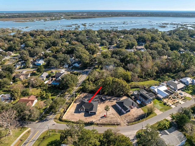 drone / aerial view with a water view and a residential view