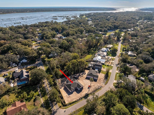 bird's eye view featuring a residential view, a forest view, and a water view