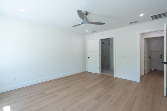 unfurnished bedroom featuring baseboards, visible vents, and light wood-style flooring