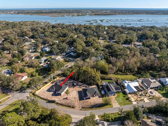 drone / aerial view featuring a water view and a residential view