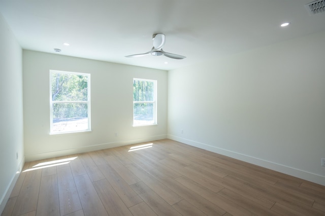 spare room with baseboards, visible vents, recessed lighting, wood finished floors, and ceiling fan