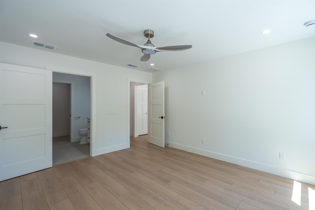 unfurnished bedroom featuring connected bathroom, baseboards, light wood finished floors, and visible vents