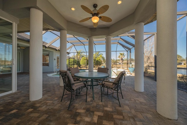 view of patio / terrace featuring a lanai, ceiling fan, and outdoor dining area