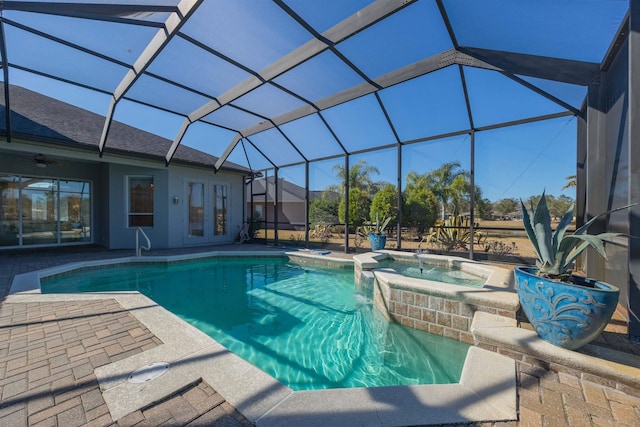 view of swimming pool featuring glass enclosure, a patio area, a pool with connected hot tub, and french doors