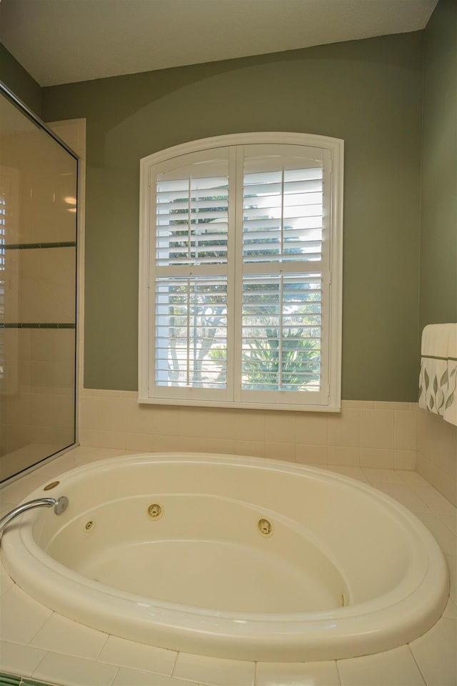 full bathroom featuring a tub with jets