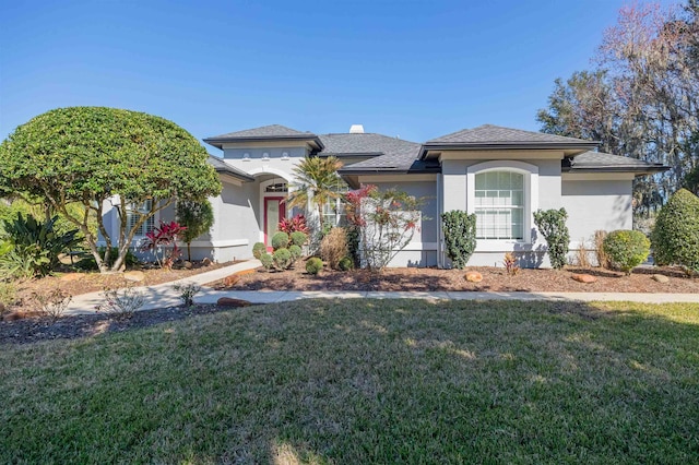 view of front of property featuring a front lawn and stucco siding