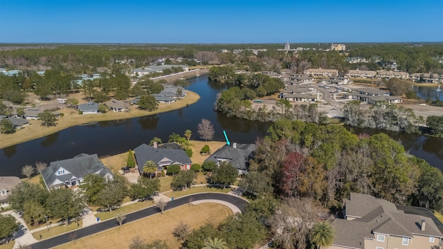 birds eye view of property with a water view and a residential view