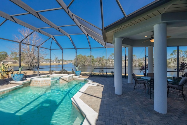 view of pool featuring a ceiling fan, a lanai, a water view, and a patio