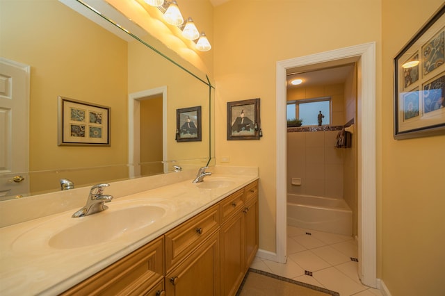 bathroom with tile patterned floors, a sink, baseboards, and double vanity