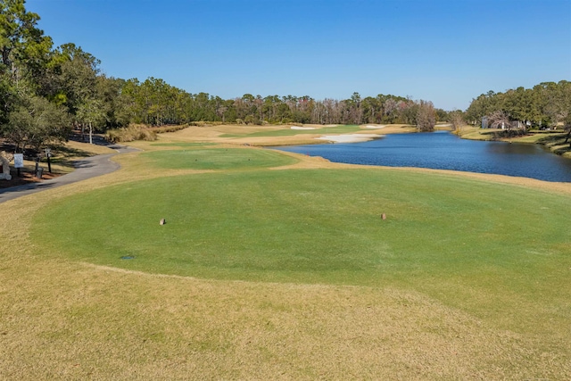 view of home's community featuring a water view, view of golf course, and a yard