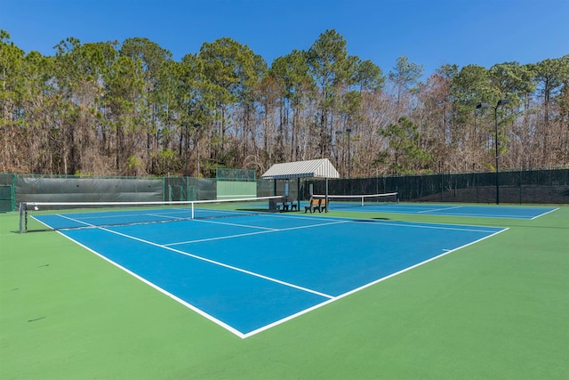 view of tennis court with fence