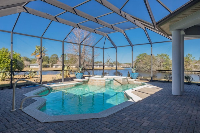 pool featuring glass enclosure, a patio area, a water view, and a hot tub