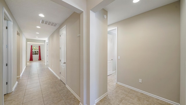 corridor featuring light tile patterned flooring