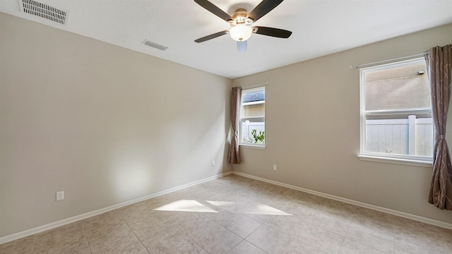 tiled empty room with ceiling fan