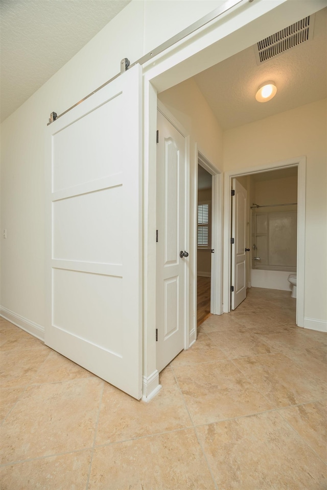 corridor featuring a textured ceiling