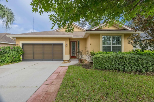 ranch-style house featuring a garage and a front lawn