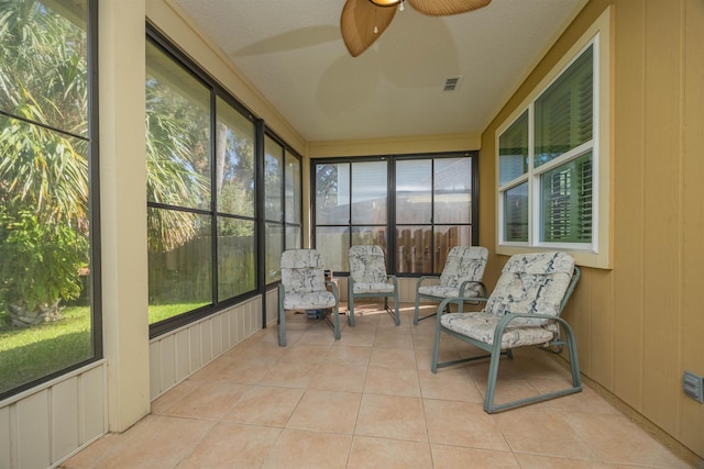 sunroom / solarium featuring ceiling fan