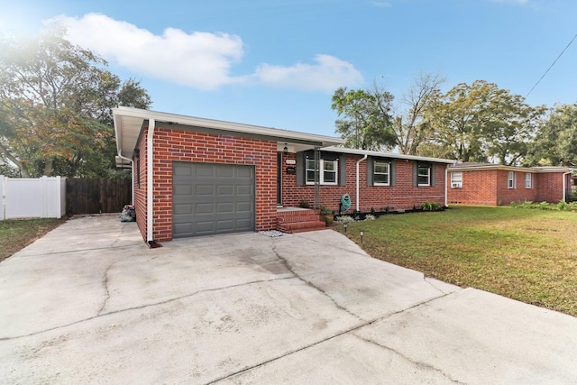 ranch-style home with a front lawn and a garage