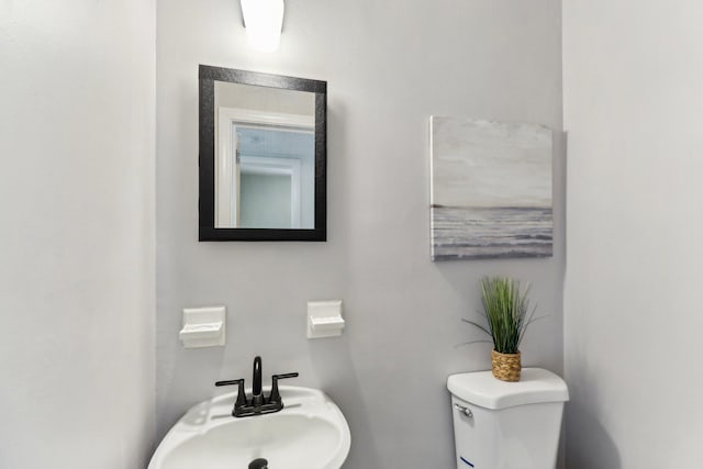 bathroom featuring sink and toilet