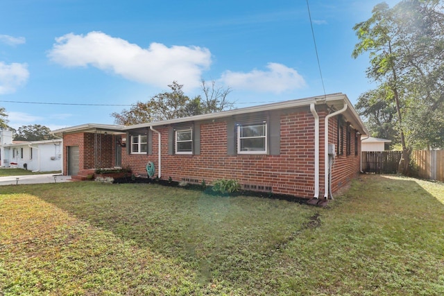 view of front of property featuring a garage and a front lawn