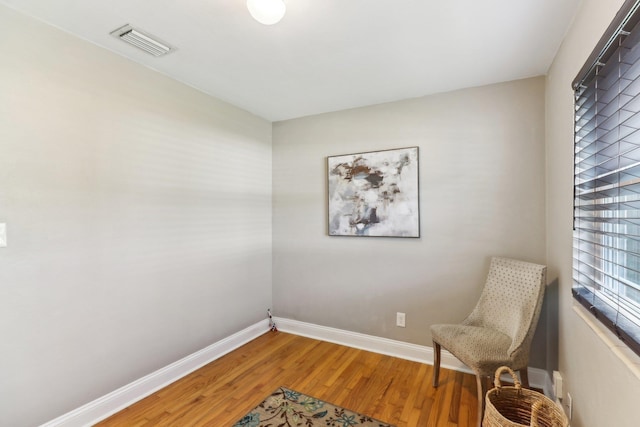 sitting room with wood-type flooring