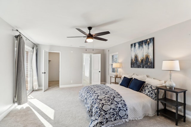 carpeted bedroom with multiple windows and ceiling fan