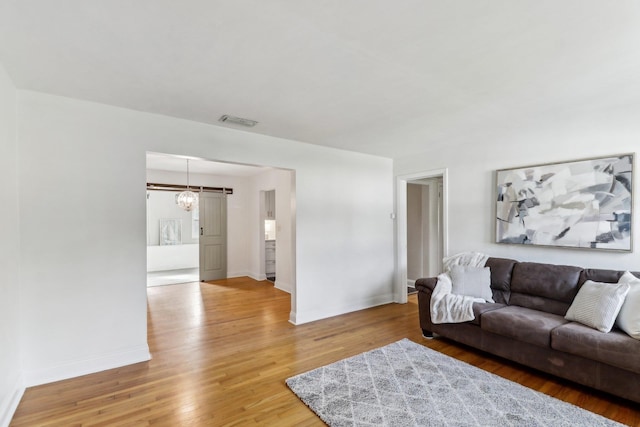 living room with hardwood / wood-style floors and a chandelier