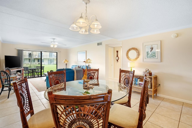 tiled dining area with ceiling fan with notable chandelier, ornamental molding, and a textured ceiling