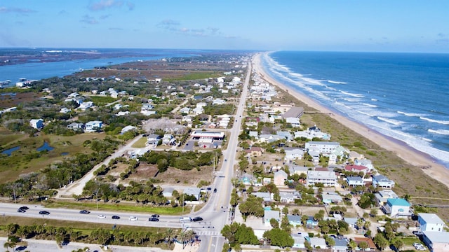 bird's eye view featuring a water view and a view of the beach