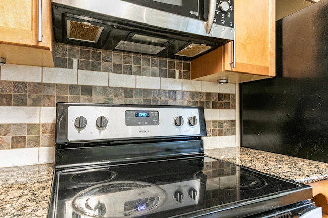 kitchen with stone counters, decorative backsplash, and electric stove